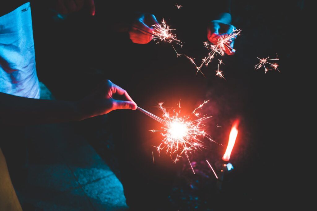 people holding sparklers