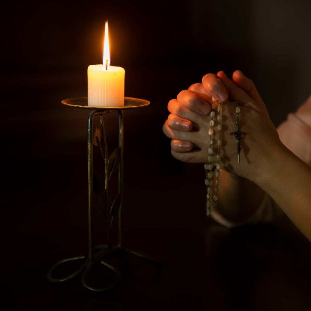 person holding white pillar candle